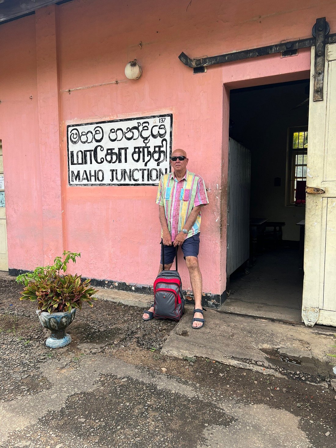 A tourist posing with a building in Sri Lanka