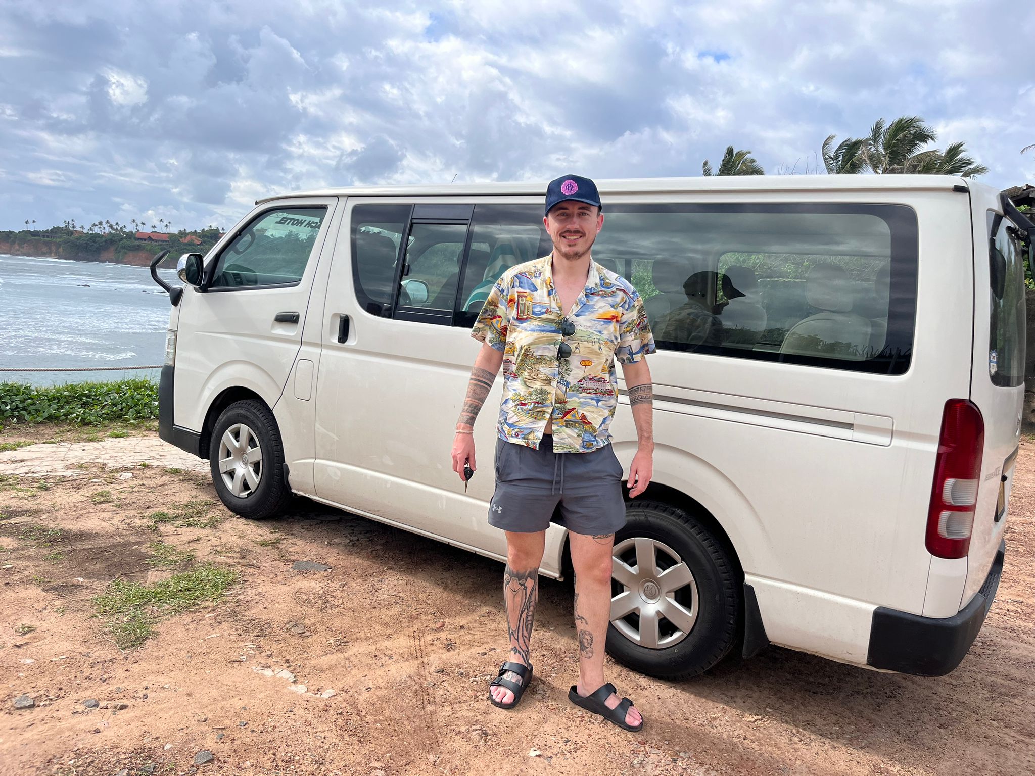 A tourist posing with a rental van in the south of Sri Lanka 